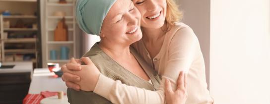 young-woman-visiting-her-mother-with-cancer-indoors