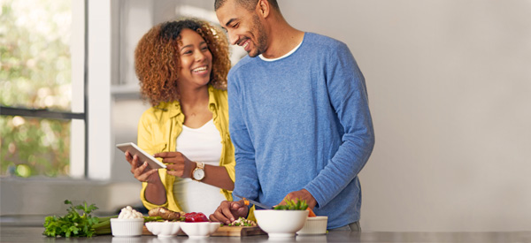 man and woman in kitchen laughing