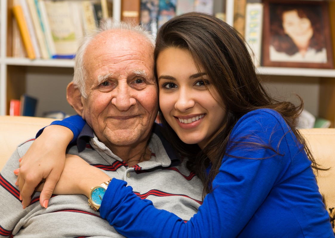 elderly old man with granddaughter in a home setting