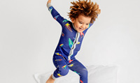 boy jumping on bed
