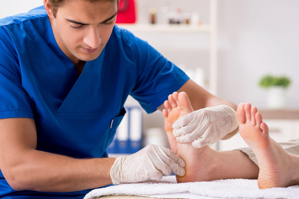 Podiatrist treating feet during procedure