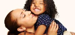 A mother holds her daughter aloft
