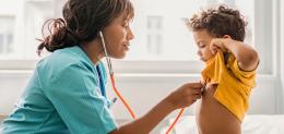 A young patient is examined by a provider