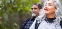 Mature woman hiking outdoors while smiling