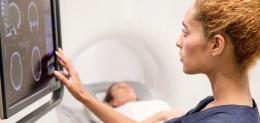 doctor looking at CT scan on screen
