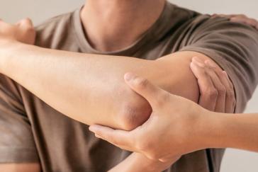 A patient has an injured limb examined following recovery from an injury