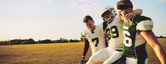 football-players-carrying-an-injured-teammate-off-the-field