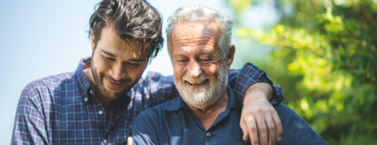 senior-father-and-adult-son-are-hugging-together