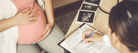 Happy pregnant woman visit gynecologist doctor at hospital