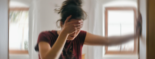 Blured photo of a woman suffering from vertigo or dizziness or other health problem of brain