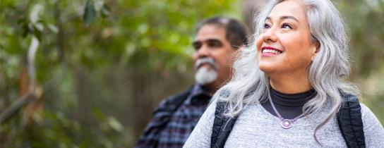 Mature woman hiking outdoors while smiling