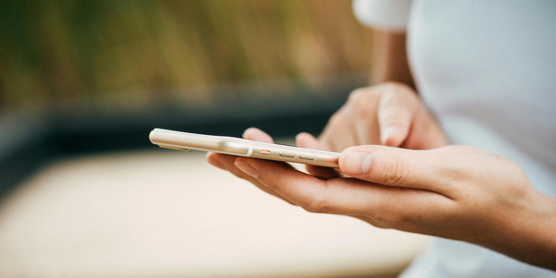 Woman viewing a cellphone in her palm