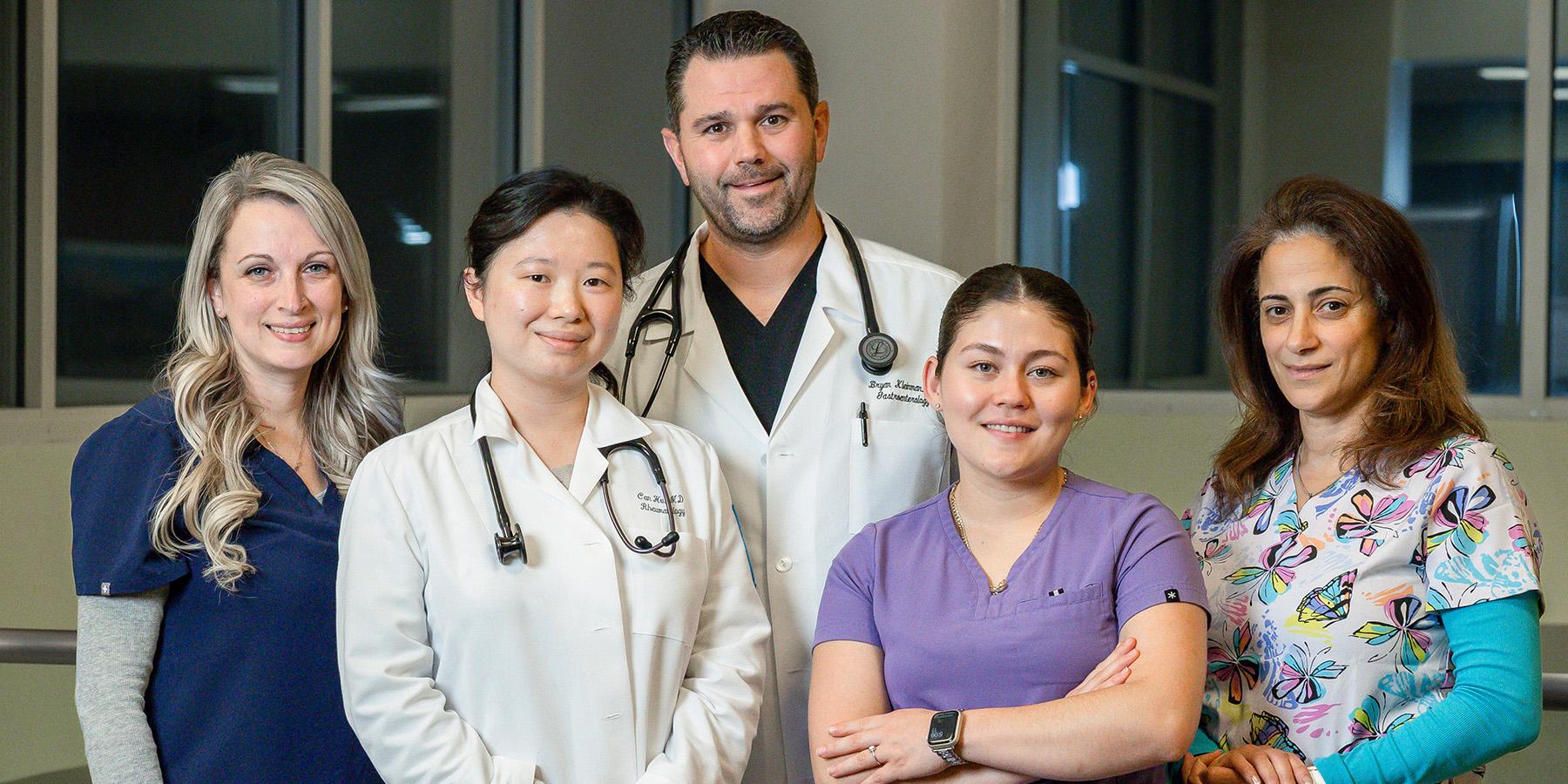 Smiling healthcare providers standing together in a group