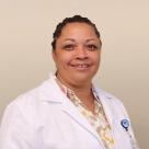 A photo of Claudean Wright, FNP smiling in a lab coat.