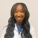 A photo of Simone Reynolds smiling in a lab coat