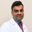 A photo of Saeed Mahmood, MD smiling in a lab coat.