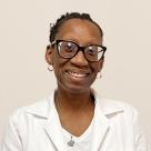 A photo of Nytishia Gillmer, NP smiling in a lab coat