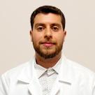 A photo of Ramy Abukwaik, MD wearing a lab coat.