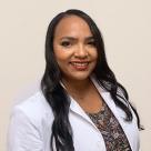 A photo of Magdeline Diaz Hurtado smiling in a lab coat