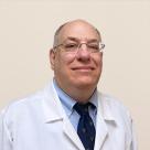 A photo of Ira Nierenberg, MD smiling in a lab coat