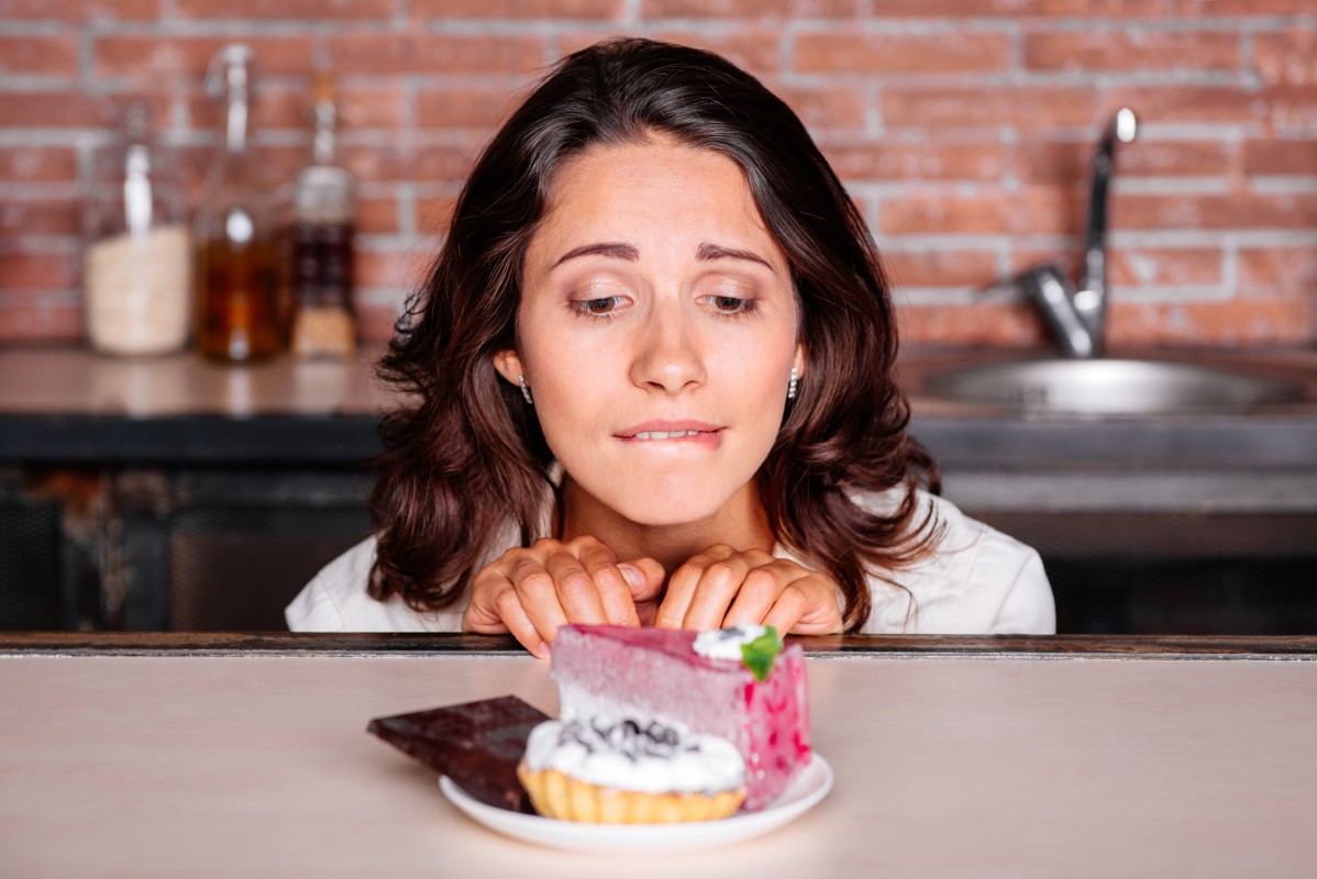 Young attractive woman really wants to eat delicious cake